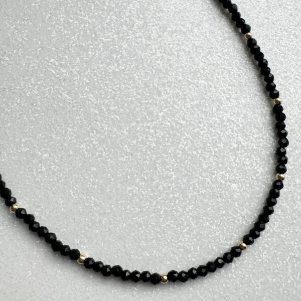 spinelio verinys su auksu Juodos spalvos špineli vėrinys